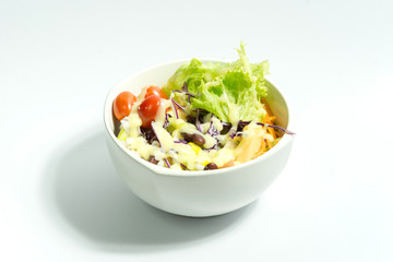 Fresh salad with salad dressing on white background