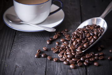Close up coffee beans on black wood table