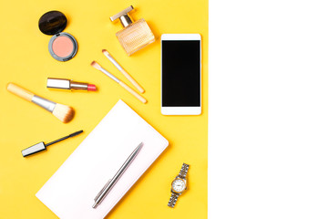 Modern woman accessories. Beauty products, smartphone, note book, accessories on a pastel background