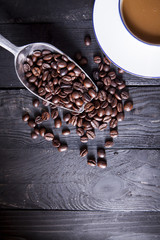 Coffee beans on black wood table with space for wording