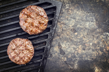 Barbecue wagyu hamburger as top view on a grillage with copy space right