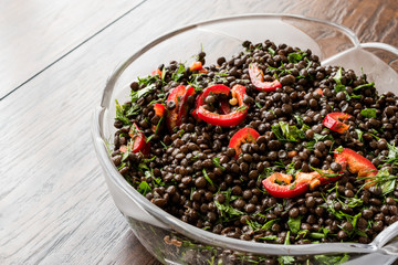 Black Lentil Salad with Red Peppers and Parsley in glass bowl.