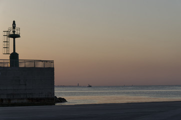 Entrance of Rimini harbor at sunset