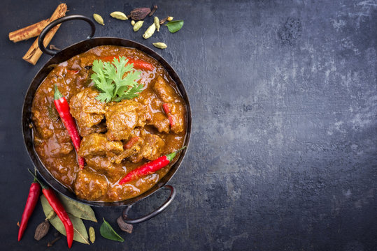 Traditional Indian curry lamb masala as close-up in a Korai with copy space right
