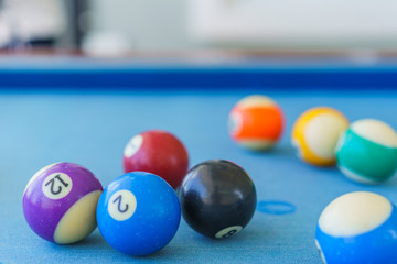 Billiard old balls colorful in a pool table.