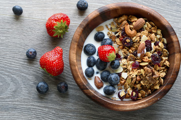 Homemade  granola with  fresh berry in wooden bowl