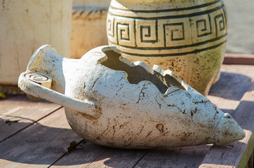 old clay jugs on a wooden table close-up