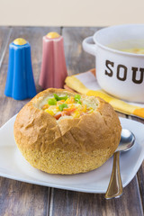 Homemade corn and cheese chowder in bread bowl.