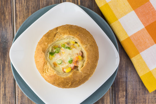 Homemade corn and cheese chowder in bread bowl.