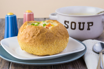 Homemade corn and cheese chowder in bread bowl.