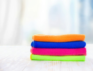 A stack of towels on a wooden table