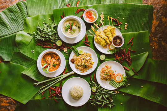 Variety of authentic thai traditional meal set on green banana leaves