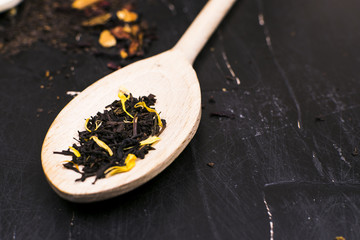 Tea in wooden spoons, lemon