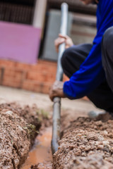 Construction worker,Repairing a broken water pipe on the concrete road.