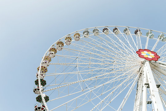 White ferris wheel over blue sky - background