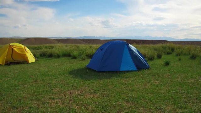 Camping tents in mongolian grassland natural landscape with Achnatherum splendens in south-west Mongolia
