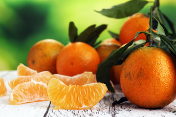 Tangerines with leaves on wooden background. Mandarins Rustic style