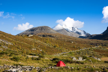 Mountain scenery with snow on the high peaks against blue sky background