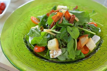 Close up rocket salad in green glass plate