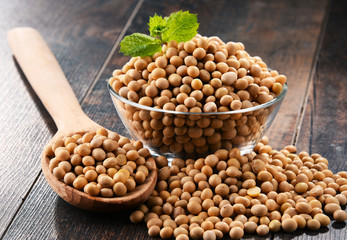 Composition with bowl of soya beans on wooden table