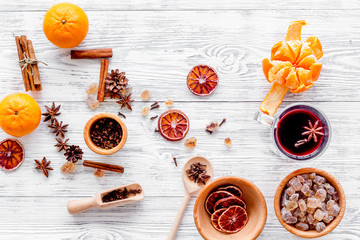 Hot mulled wine or grog cooking for new year celebration with oranges and spices ingredients on...