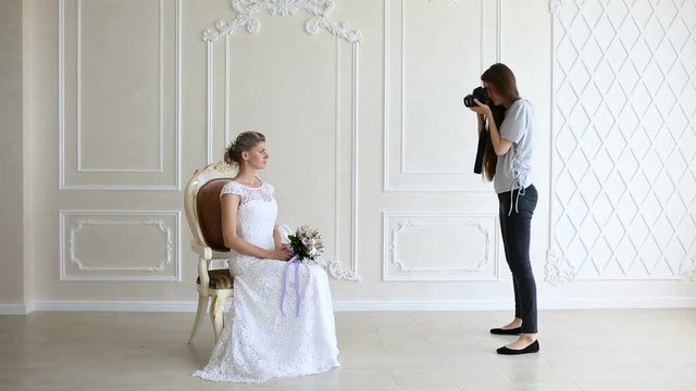 Photographer taking pictures the young sexy bride