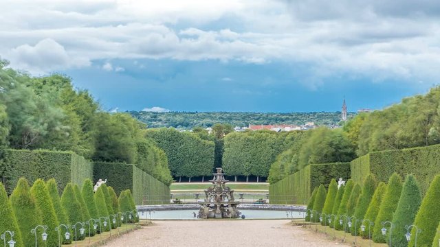 Well-groomed alley in the garden and fountain on background timelapse. Versailles, France.