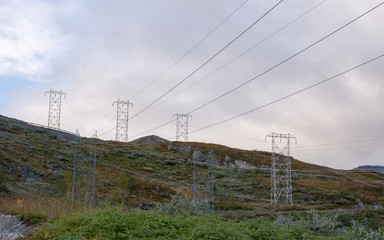 Fototapeta premium Hydro electric power lines crossing mountainn