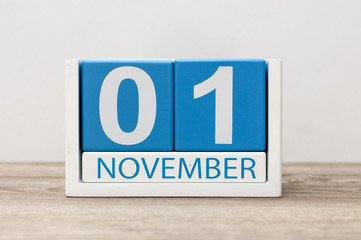 November 1st. Day 1 of month, wooden color calendar on light background. Autumn time
