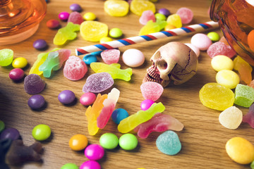 colorful halloween candy dessert party on wood ground