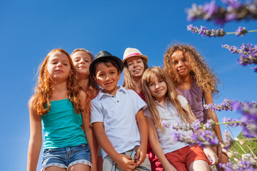 Bottom view of happy children against clear sky