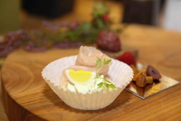 Canape with meet on the wooden board 