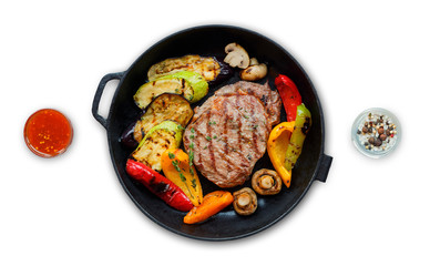 Grilled beef steak and vegetables in pan isolated