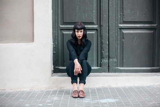 Woman waiting in front of a door