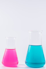  research, science and clinic background. 96 well micro plate and  laboratory beakers with colorful liquids and reagents.  