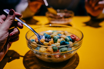 .Having a bowl of cereal with milk for breakfast. Lifestyle photography.