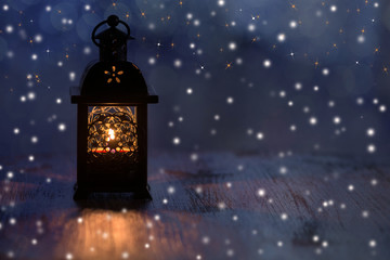 Christmas lantern with snowflakes and stars on a blue background.