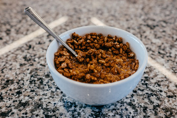 .Having a bowl of cereal with milk for breakfast. Lifestyle photography.