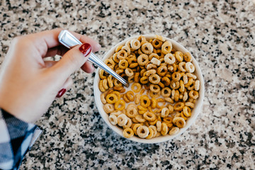 .Having a bowl of cereal with milk for breakfast. Lifestyle photography.
