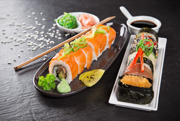 Japanese sushi set on a rustic dark background.