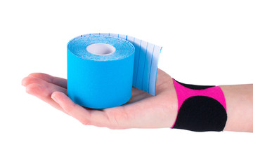 hand with kinesiology tape. Physiotherapy and therapeutic tape for wrist pain, aches and tension....