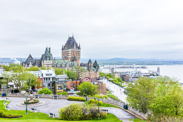Cityscape or skyline of Chateau Frontenac, Dufferin Terrace, park and Saint Lawrence river at overlook in old town