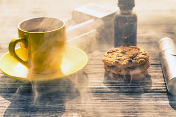 Still life with electronic cigarette with botle and coffe on the wooden background