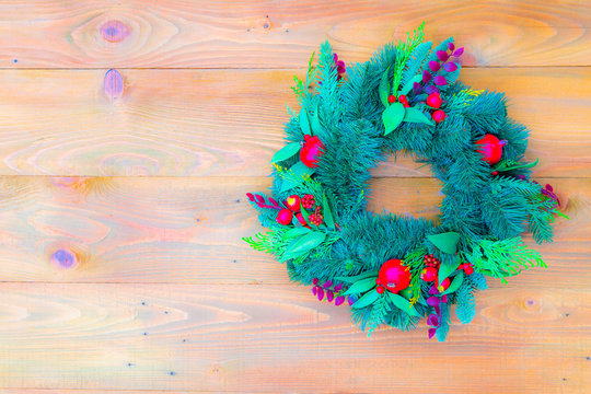 Decorative christmas wreath on the snow winter door, soft focus, top view