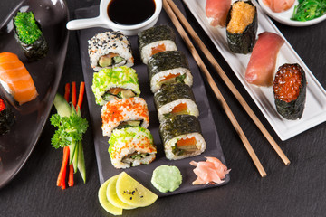 Japanese sushi set on a rustic dark background.