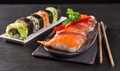 Japanese sushi set on a rustic dark background.
