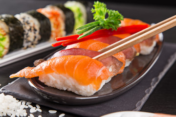 Japanese sushi set on a rustic dark background.