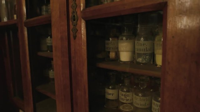 Vintage drugstore shelves. Old pharmaceutical bottles with labels. First medicine breakthroughs.
