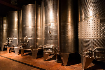 cellar with modern metal wine barrels rows