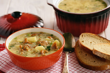 Vegetarian cuisine - soup with potatoes and chanterelles mushroom.